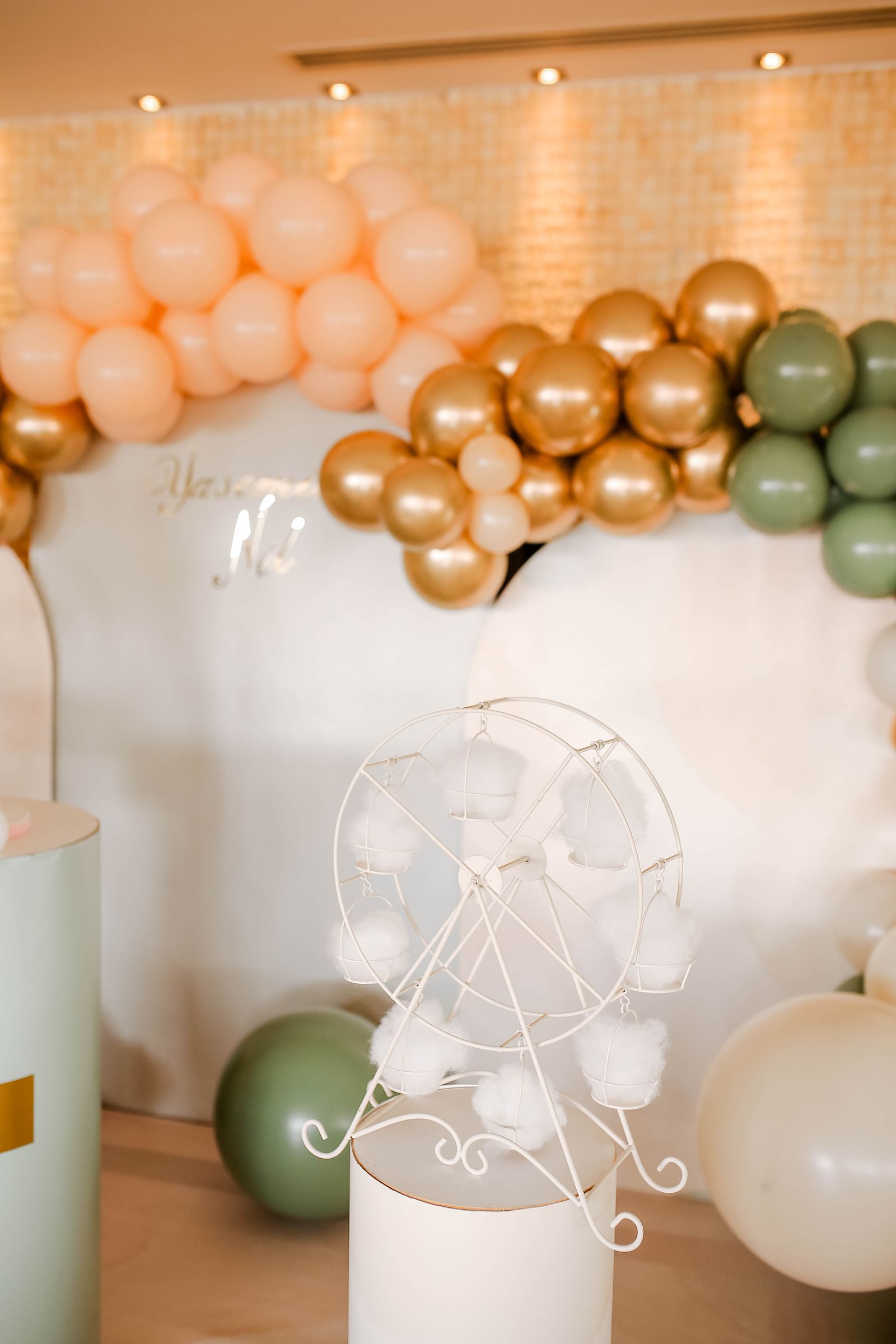 A sage and blush balloon arch styled for a birthday